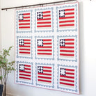 Quilt with American flag pattern hanging on a wall