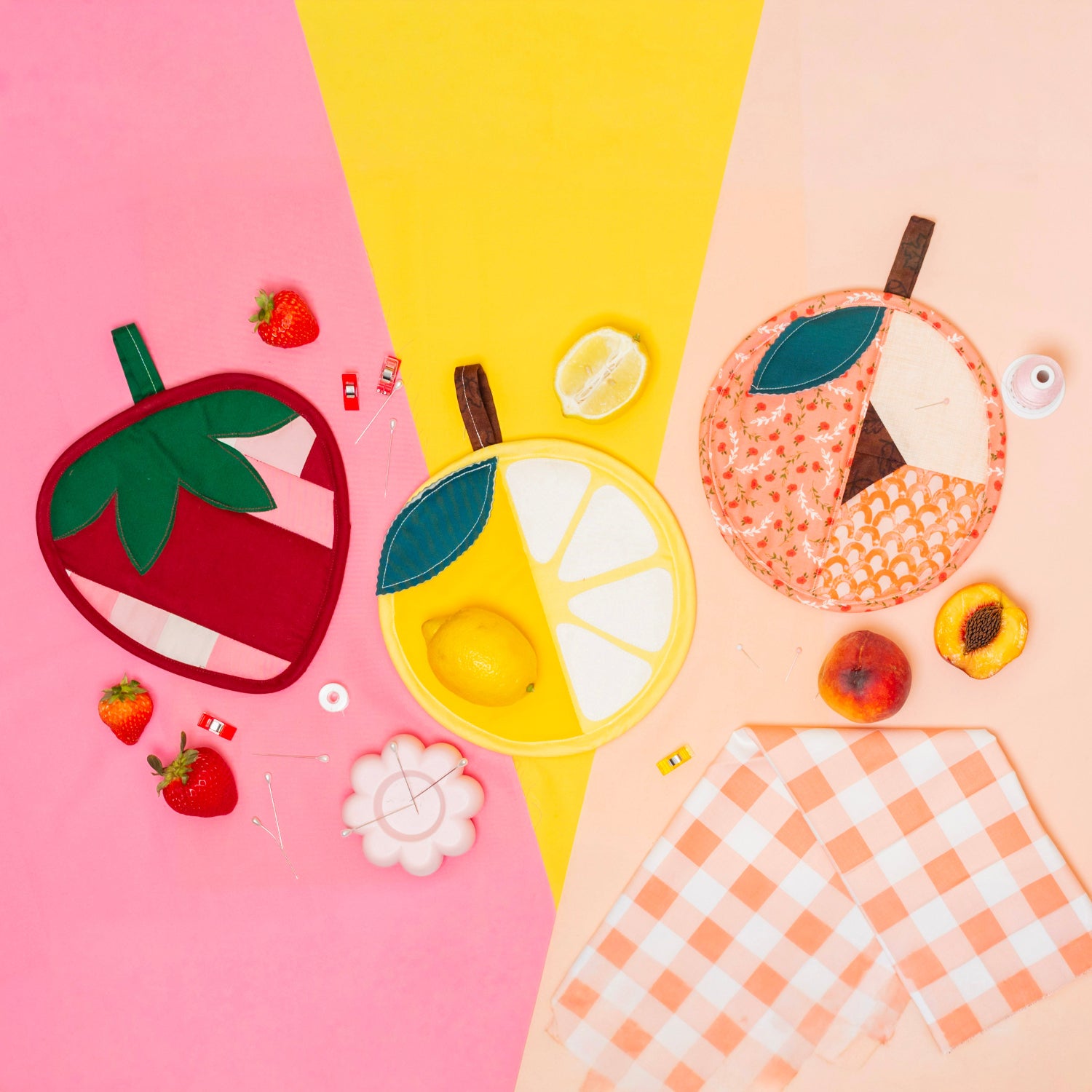 Fruit-themed coasters on a colorful background with checkered fabric.