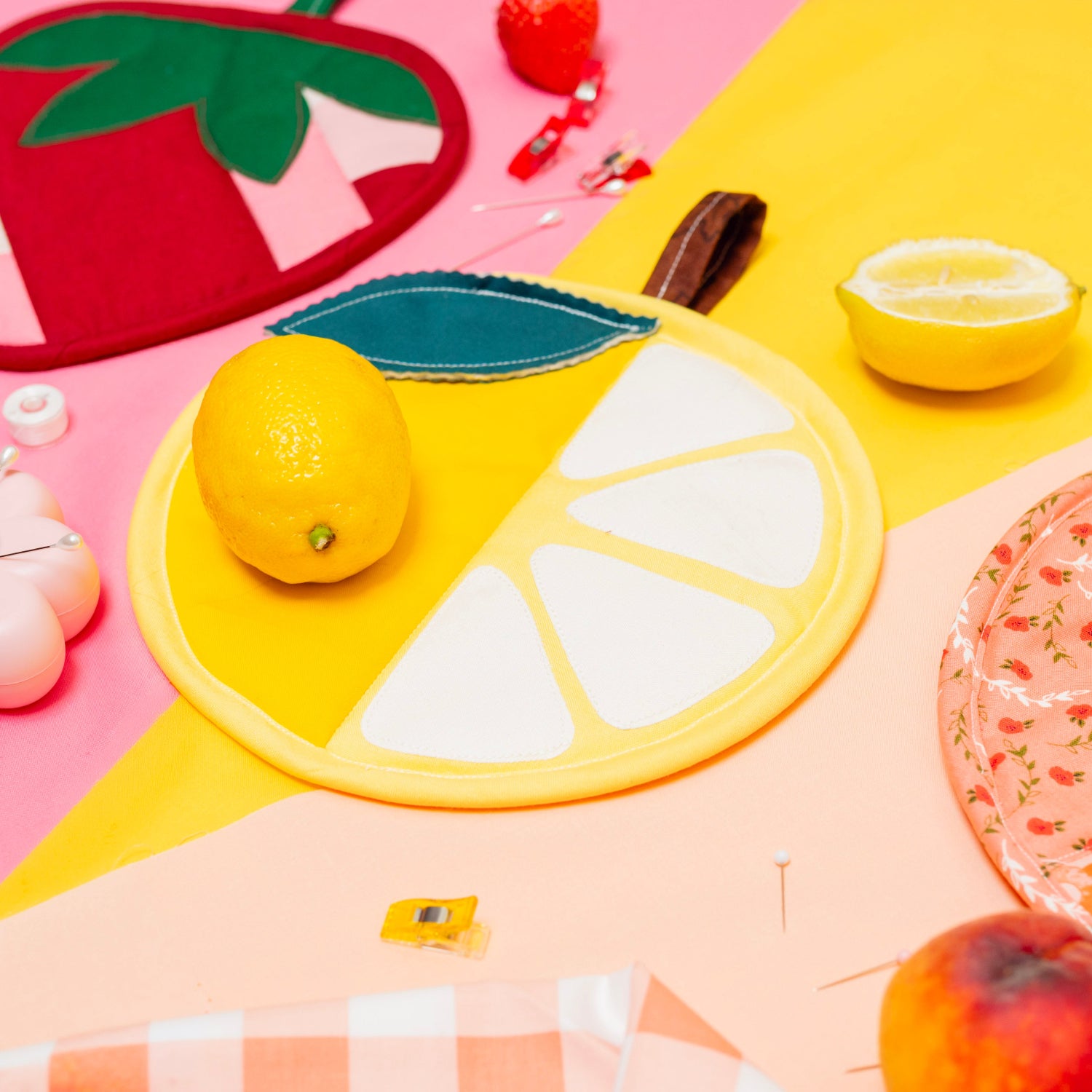 Colorful coasters with fruit designs on a pink and yellow background