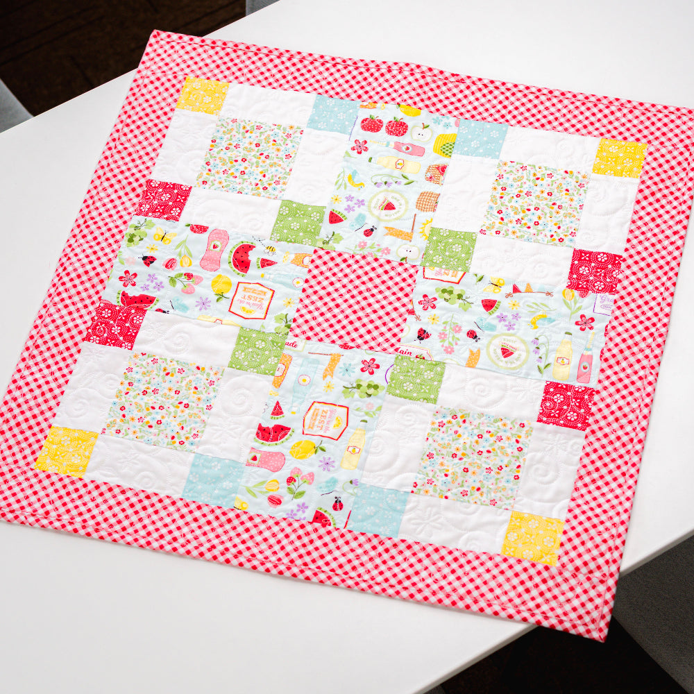 Patchwork quilt with colorful patterns on a white surface