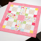 Patchwork quilt with colorful patterns on a white surface