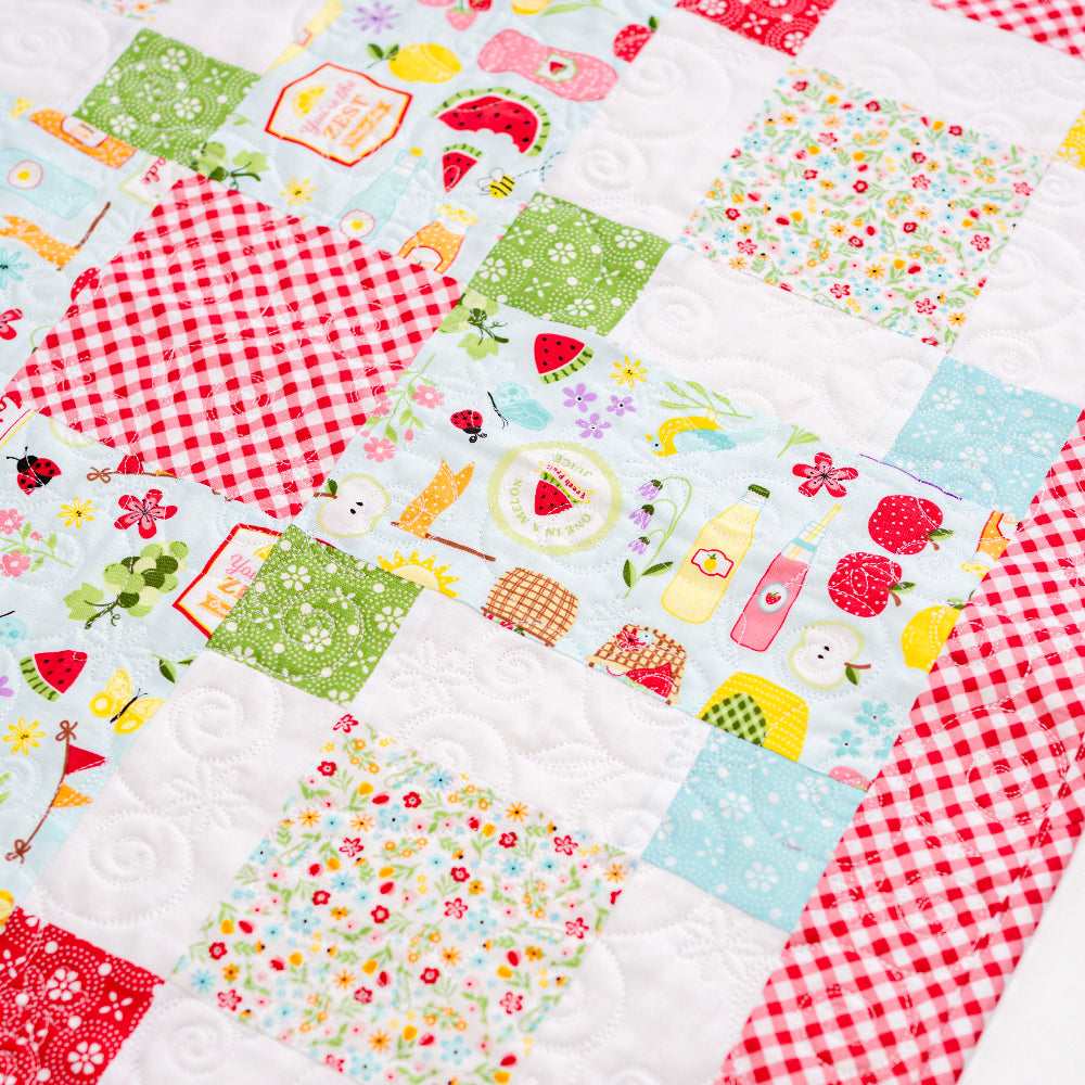 Patchwork quilt with colorful fabric squares featuring various patterns.