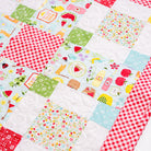 Patchwork quilt with colorful fabric squares featuring various patterns.