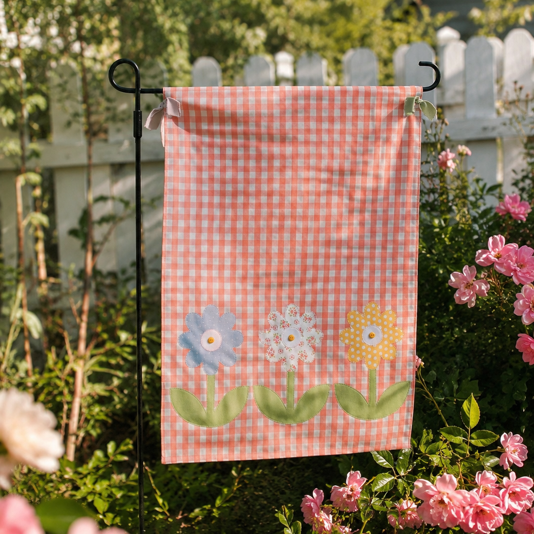 Decorative garden flag with floral design on a stand in a garden setting