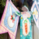 Decorative Easter-themed cards with bunnies and carrots on a blurred natural background