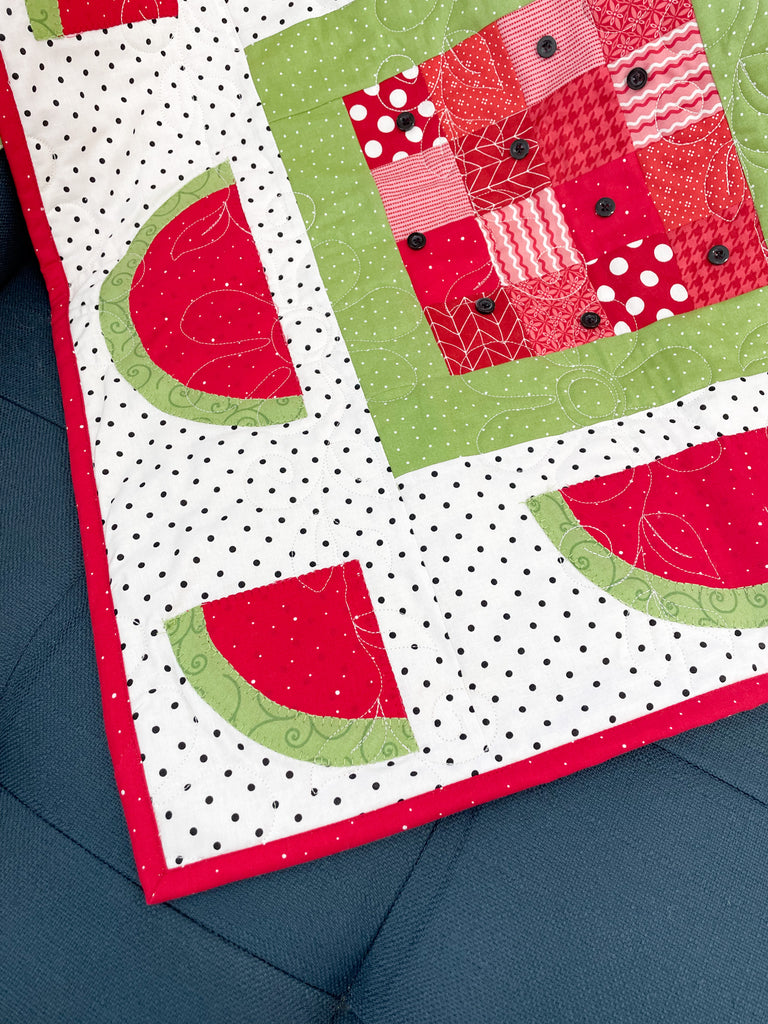 Watermelon Days Table Topper on a blue surface 