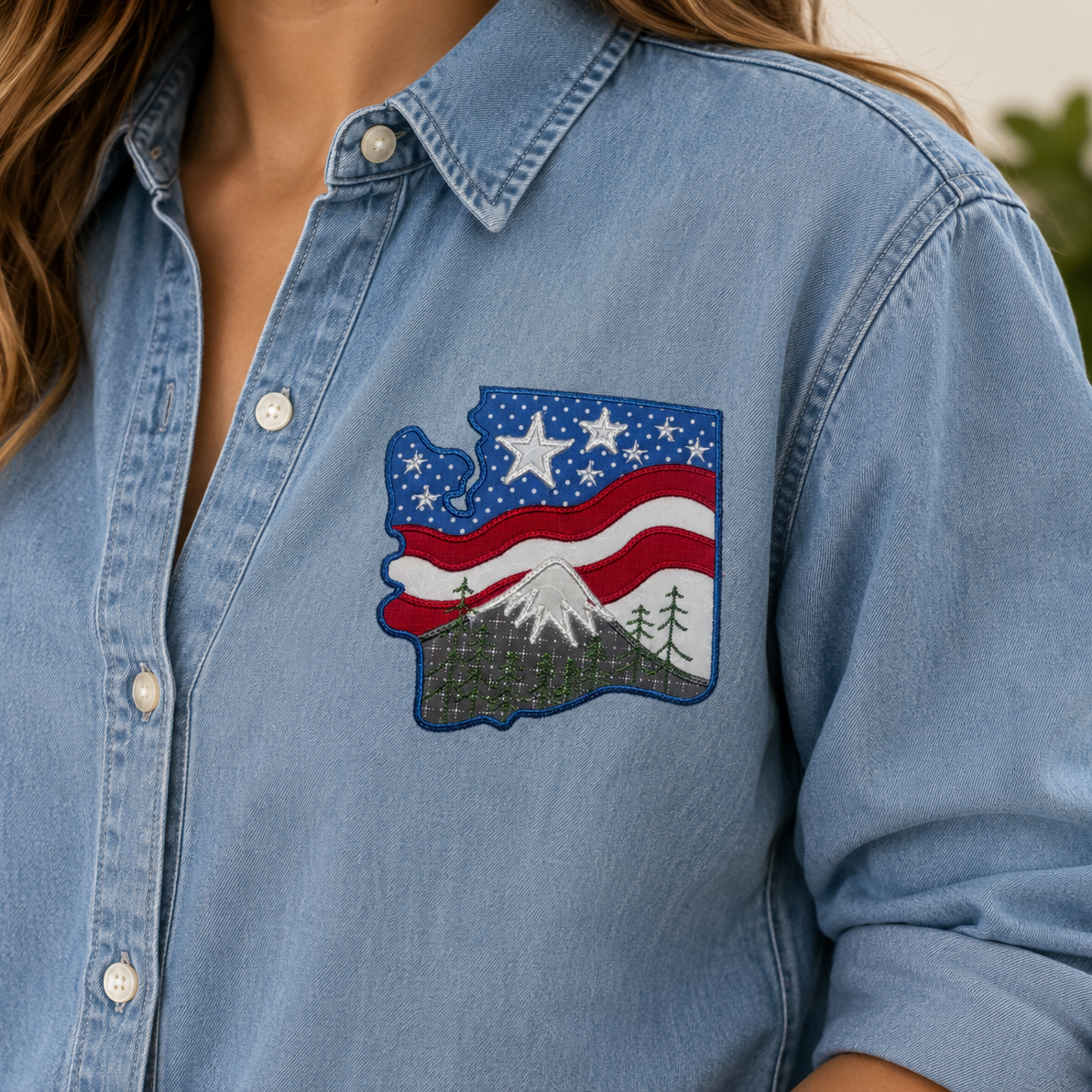 Blue denim shirt with a patch of an American flag and mountains.