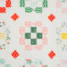 Quilt with colorful square pattern on a white background