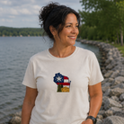 Woman wearing a t-shirt with a graphic design by a body of water