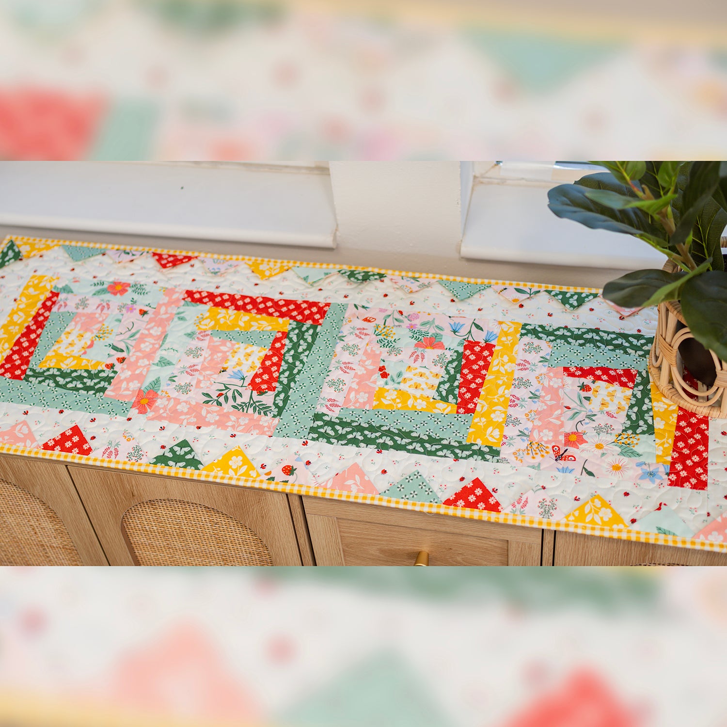 Colorful patchwork table runner on a wooden surface with a blurred background