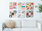 Mini Quilts Vol. 2 hanging on a wall above a couch 