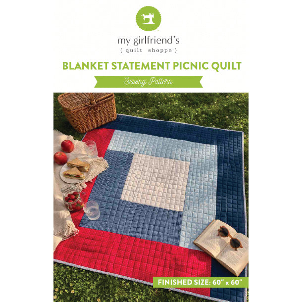 Blanket statement picnic quilt with picnic setup on grass, featuring 'my girlfriend's quilt shoppe' branding.