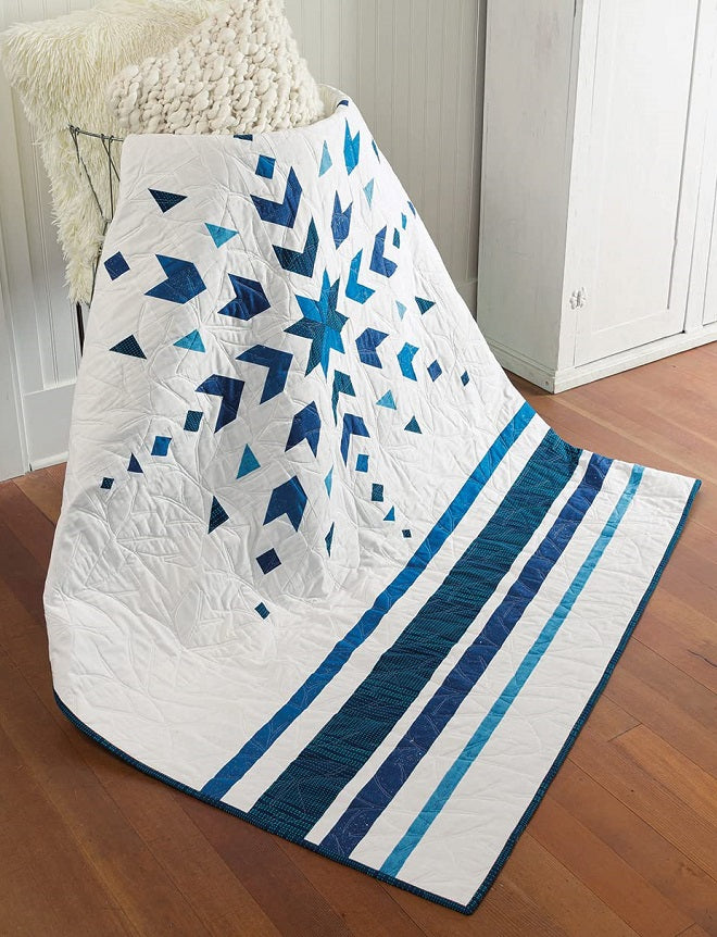 blue snowflake pattern with blue stripes below on a white background quilt 