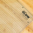 Grid-patterned cutting mat with 'Cutterpillar' branding on a wooden surface