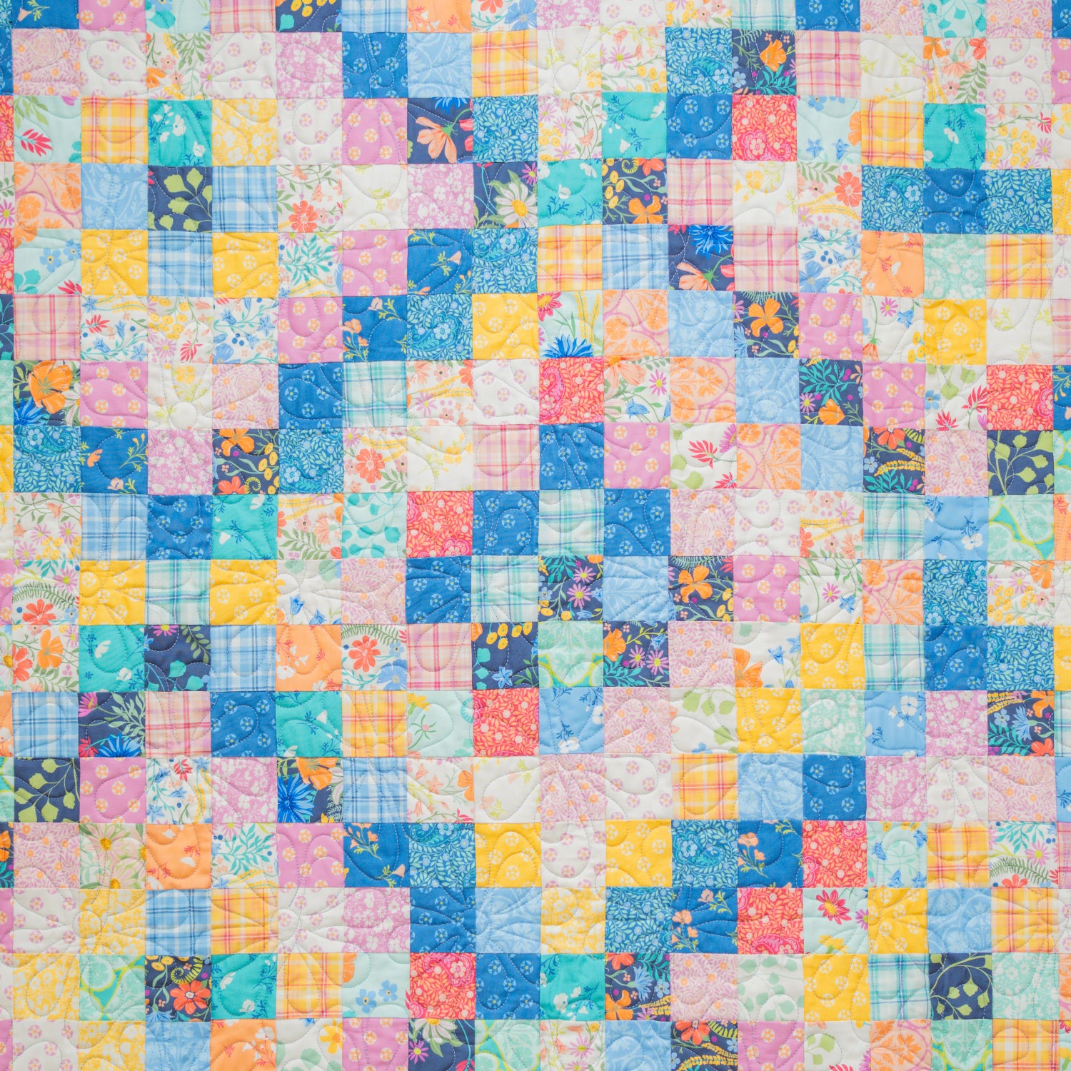 Multicolored patchwork quilt with square patterns
