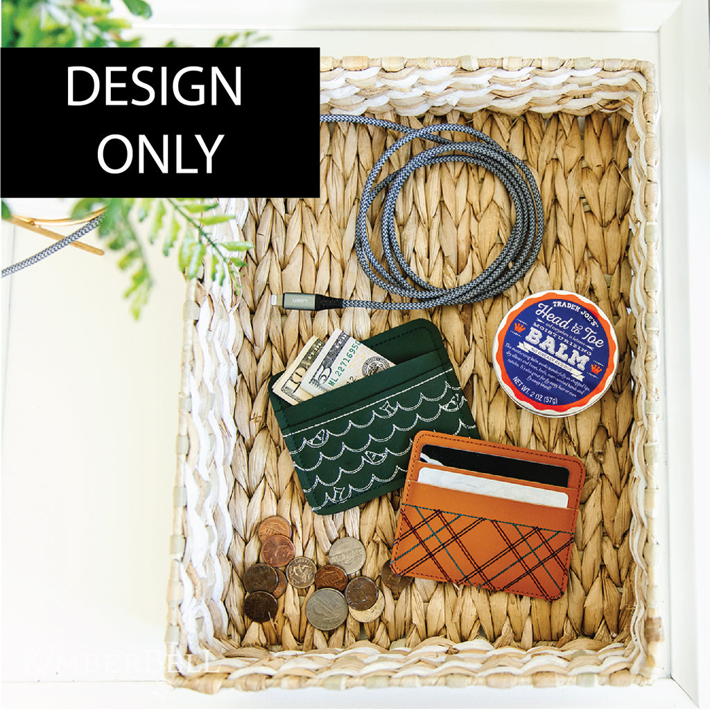 Two embroidered leather card wallets in a woven basket. 