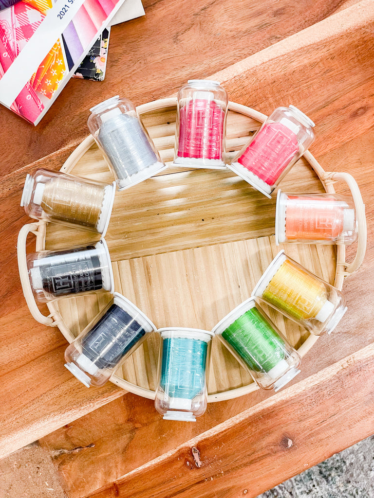 10 multicolored spools of embroidery thread