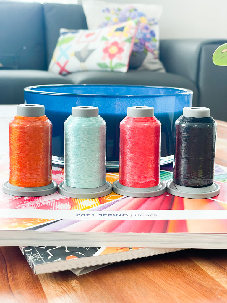 Glide embroidery thread in four bright colors.