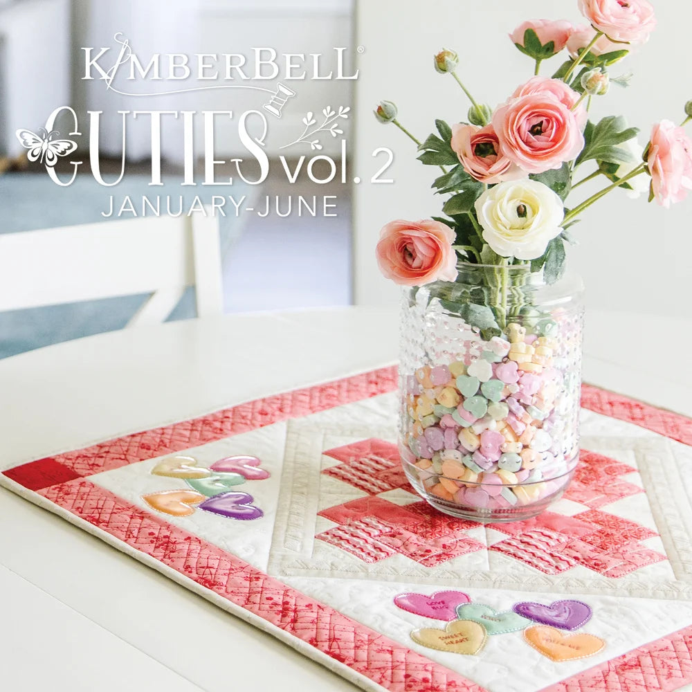 A vase of flowers on a Kimberbell table topper