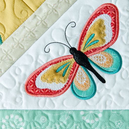 A close-up of a brightly colored embroidered butterfly.